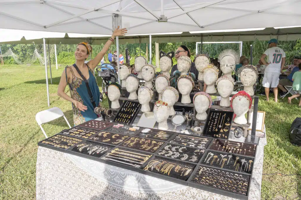 Woman selling jewelry at outdoor market stall