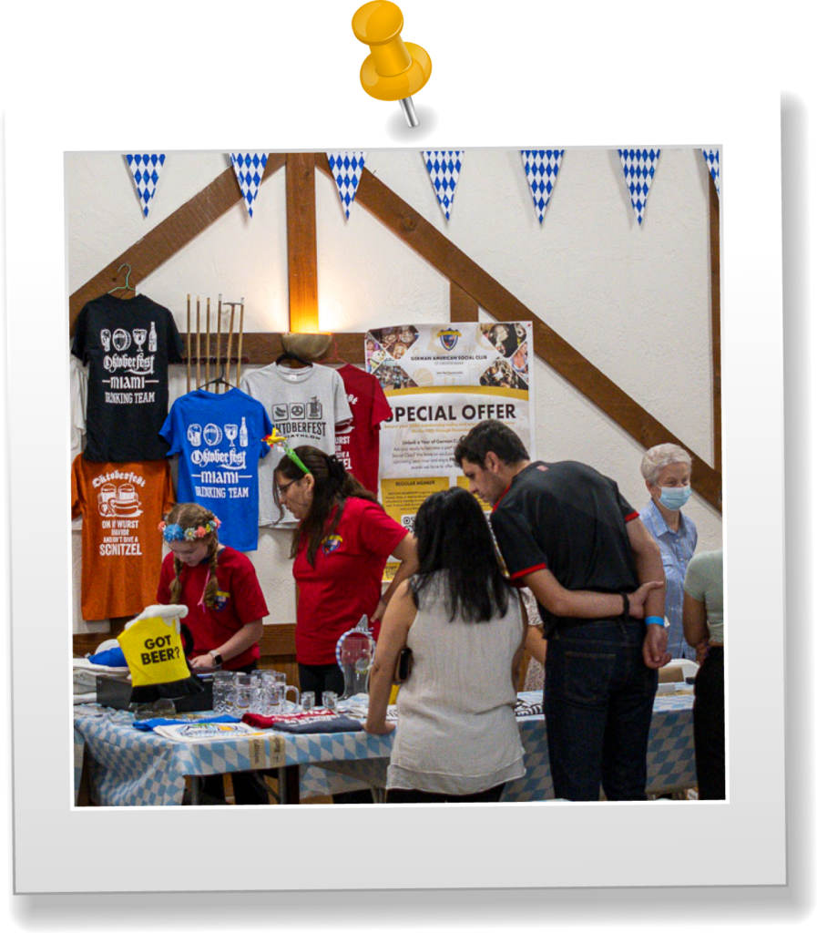 People buying items at Oktoberfest booth.