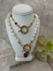 Pearl necklace with gold clasp and colorful beads.