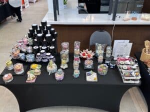 Handcrafted soap and candle display at market.