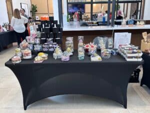 Table with decorative gift baskets and products on display.