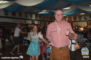 Smiling people at Oktoberfest Miami 2025 celebration.