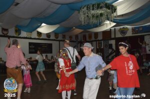 People dancing at Oktoberfest Miami 2025 celebration.