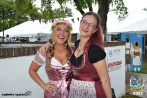 Two women in dirndls at Oktoberfest Miami 2025.