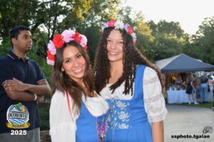 Two women in traditional dresses at Oktoberfest Miami.