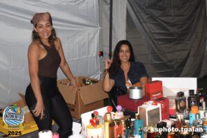 Women selling perfumes at Oktoberfest Miami 2025 event.