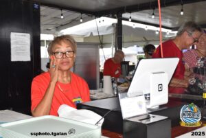 Oktoberfest Miami volunteers serving at event booth.
