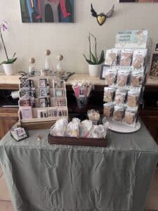 Table with handmade crafts and cards display.