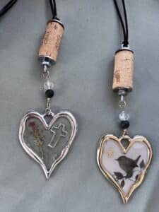 Heart-shaped charms with cork tops and designs