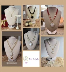 Assorted elegant necklaces and earrings display on stands.