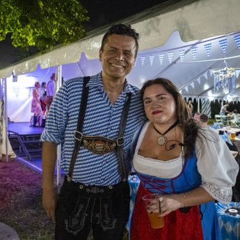 Couple in traditional clothing at Oktoberfest event.