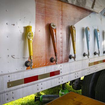 Beer taps on truck at outdoor event.