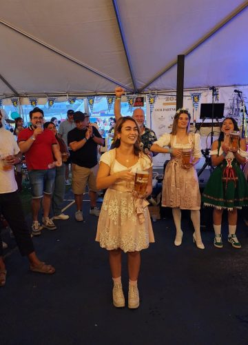 People celebrating Oktoberfest in traditional clothing.