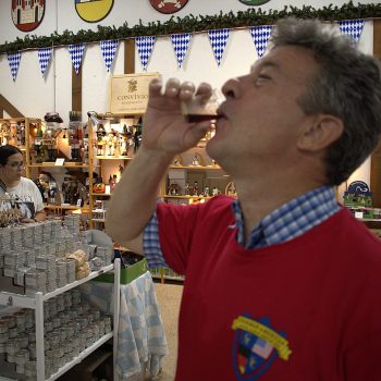 Man drinking at indoor market stall